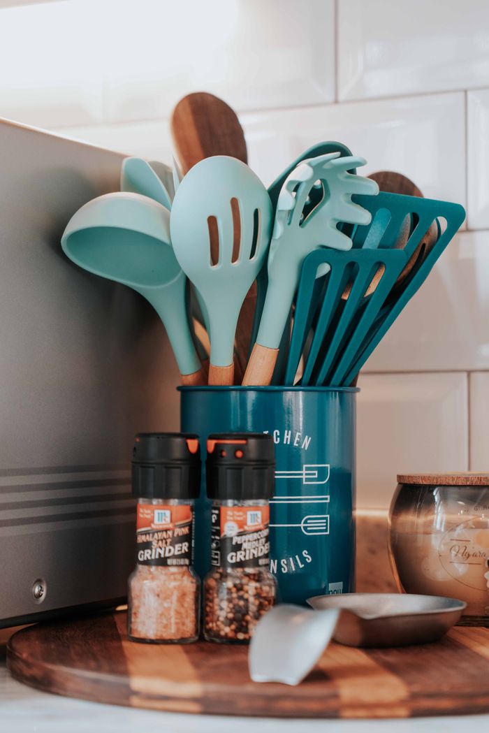 vision Aesthetic kitchen utensils and spices setup on a wooden board for modern decor.