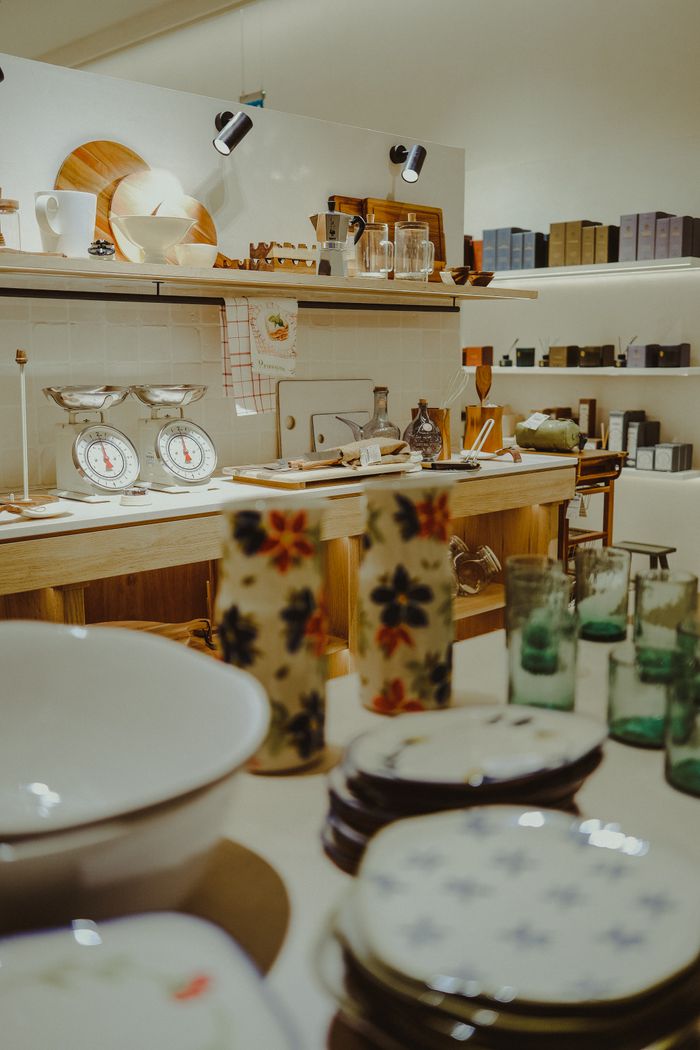 trusted-partner Charming kitchen scene featuring vintage scales and floral ceramics.