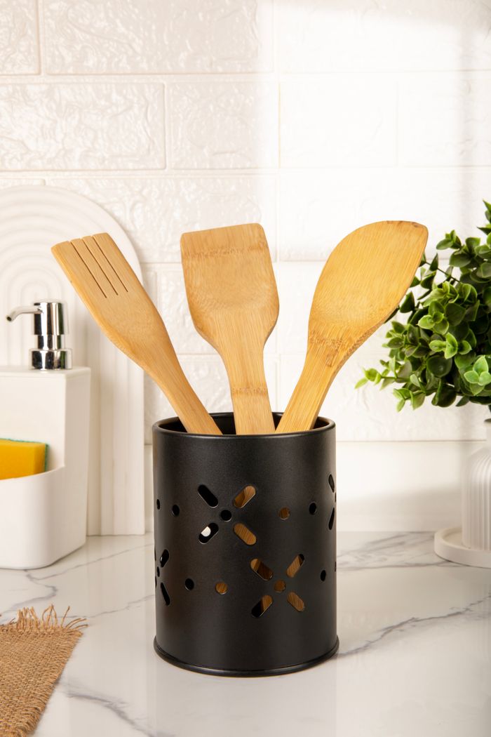journey-01 Stylish bamboo utensils in a modern black holder on a kitchen counter.